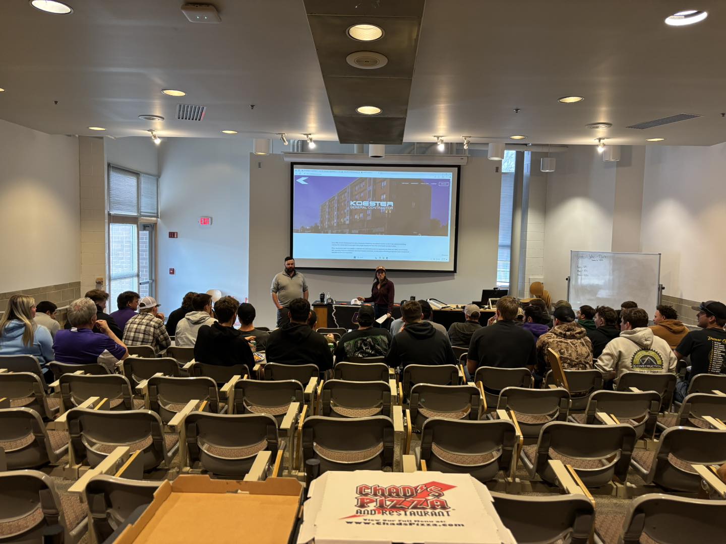 students in a classroom listening to a guest speaker