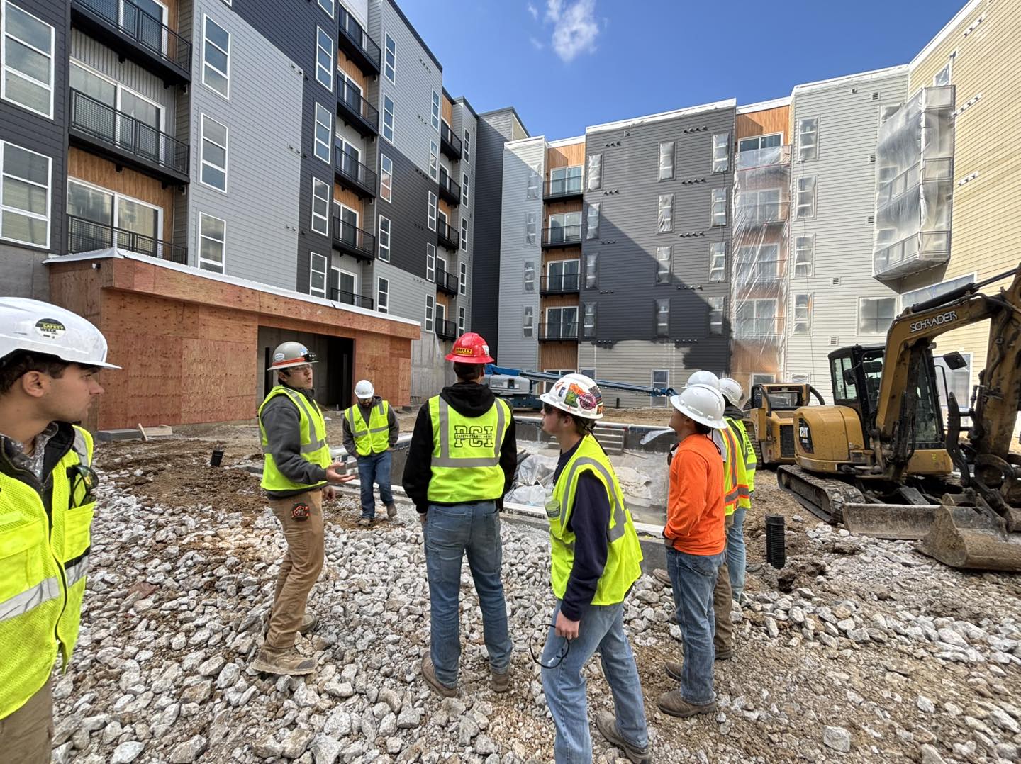 Students in hard hats at a construction job site 
