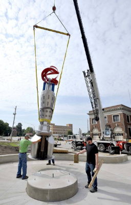 Crane dropping in components of a sculpture into an installation spot.