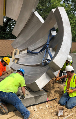 Construction being done on a large outdoor sculpture.