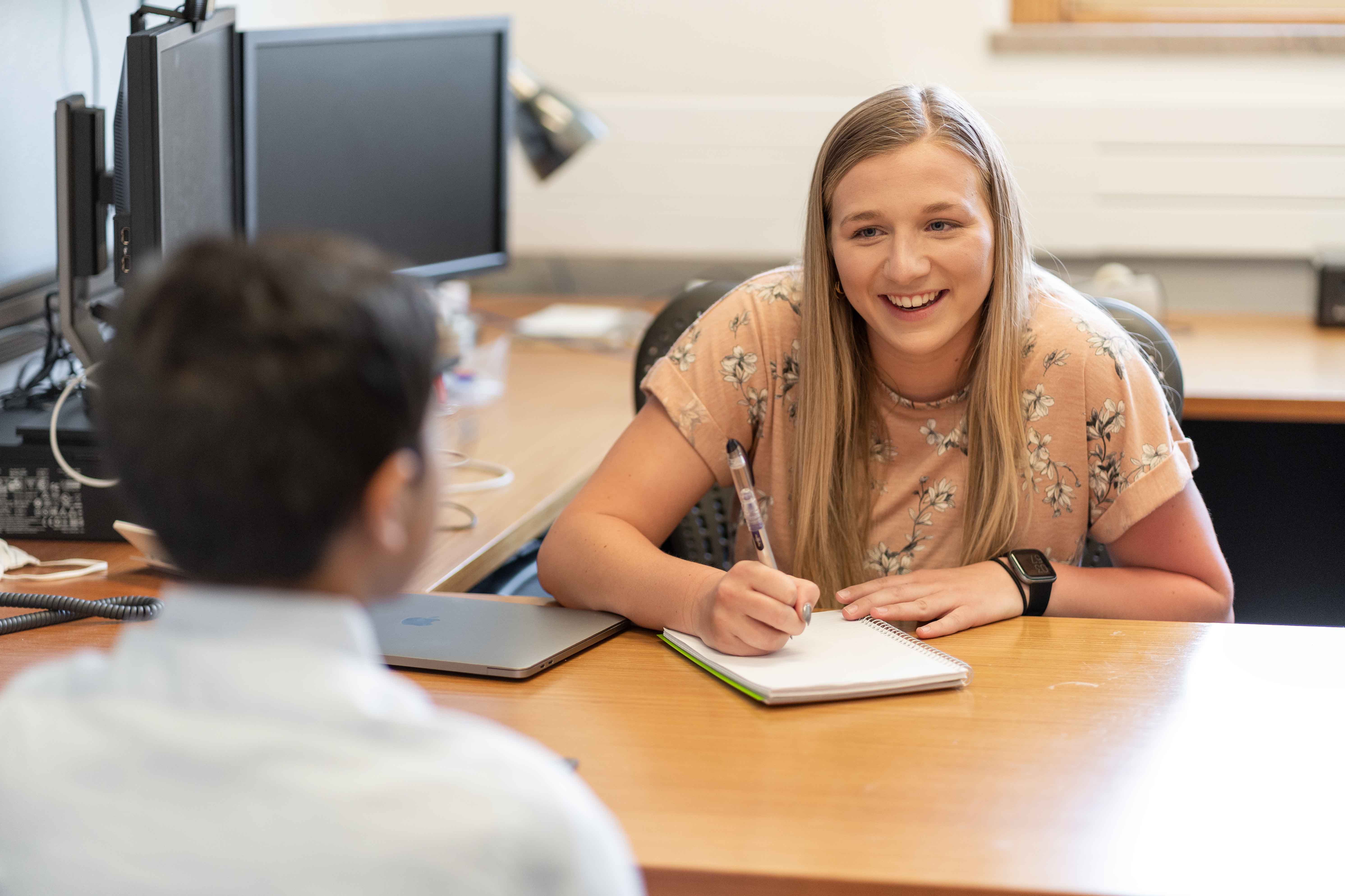 Student working with student in office
