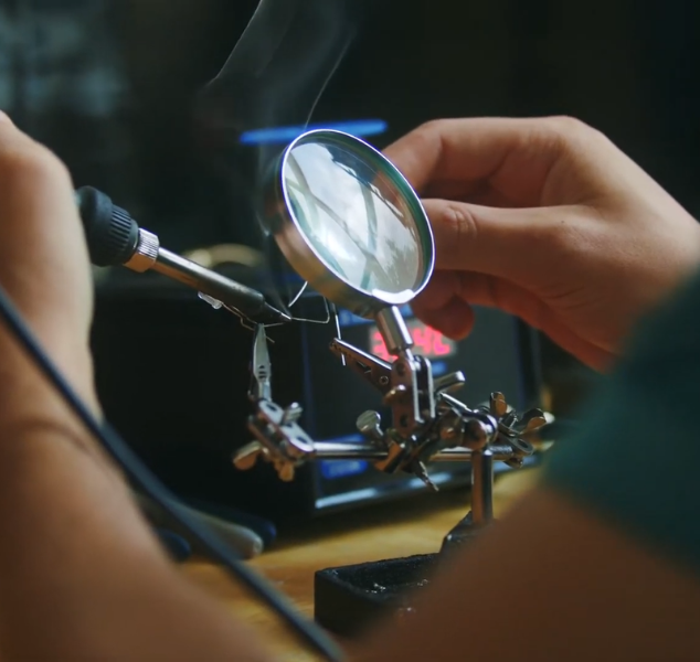 a close up of a student working on a piece of physics equipment