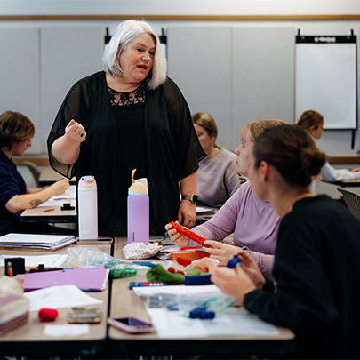 a female faculty member leading a class 