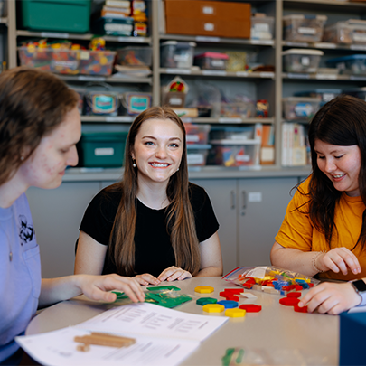 three female students working together on a project