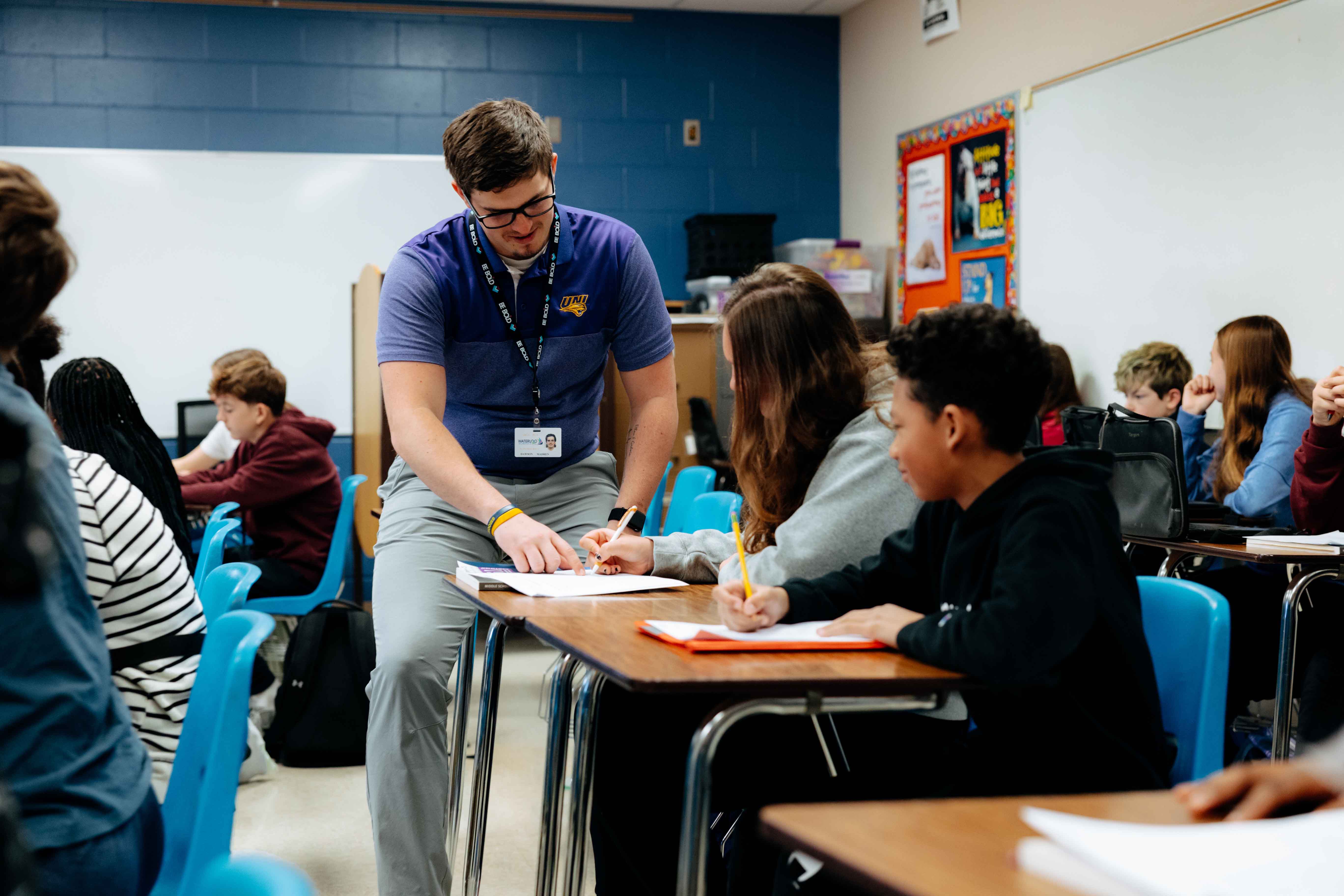 Student teacher working with kids in math classroom