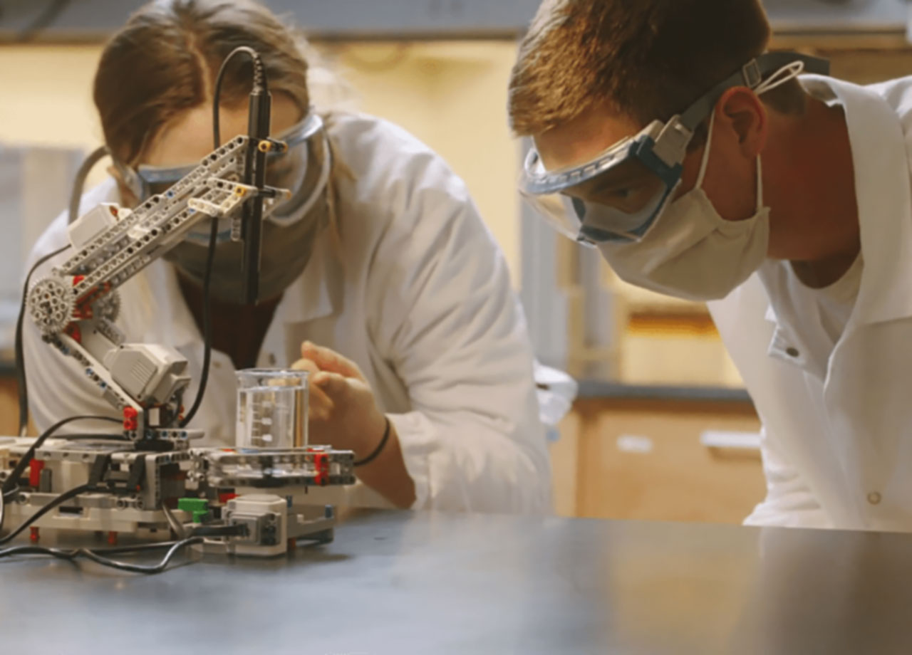 Two students performing robotics experiment.