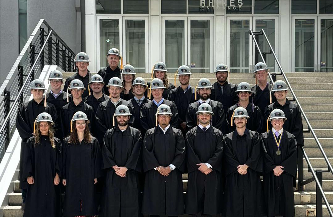 a group of construction management graduates in hard hats