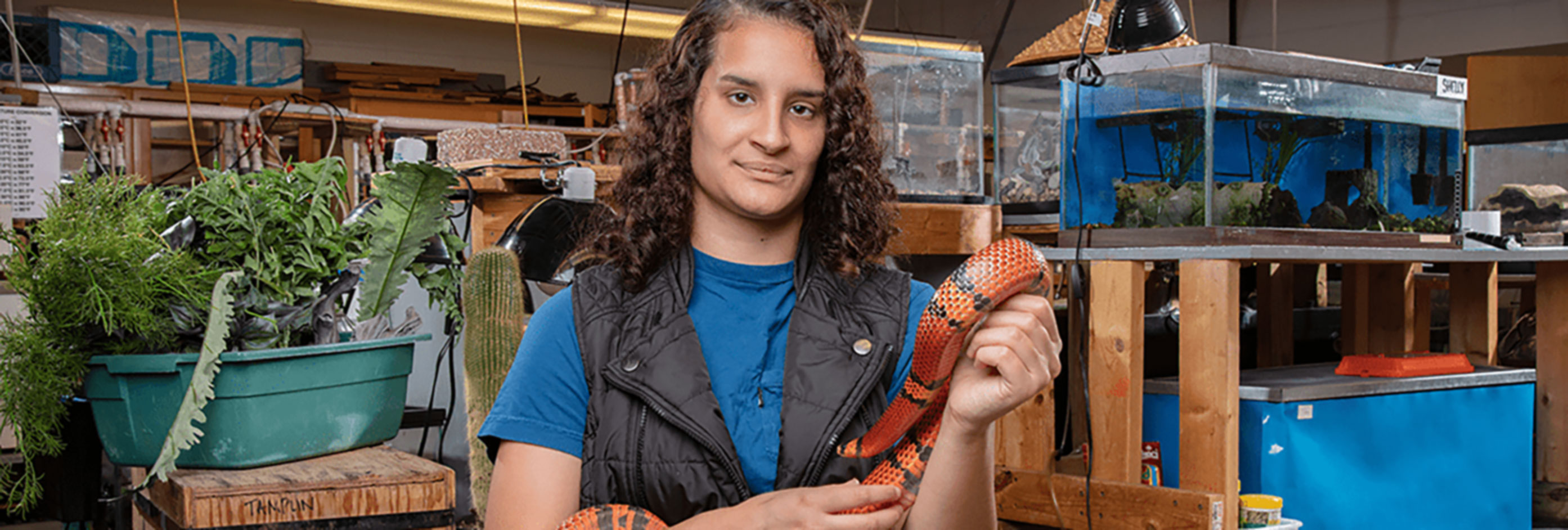 Student holding a snake.