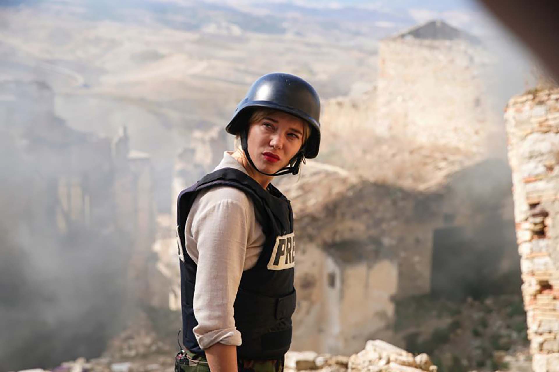Photo of woman on hillside wearing a combat helmet