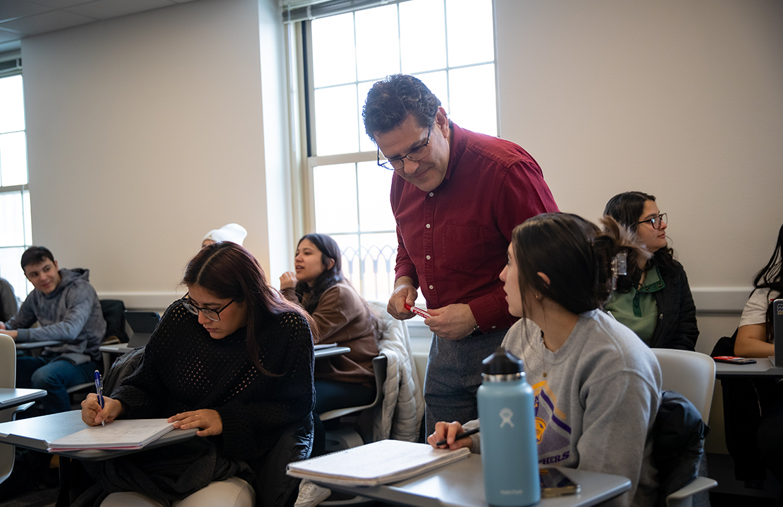 students in Spanish class talking to professor 