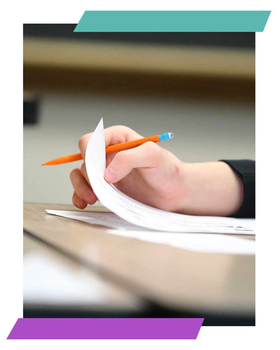 student writing on paper