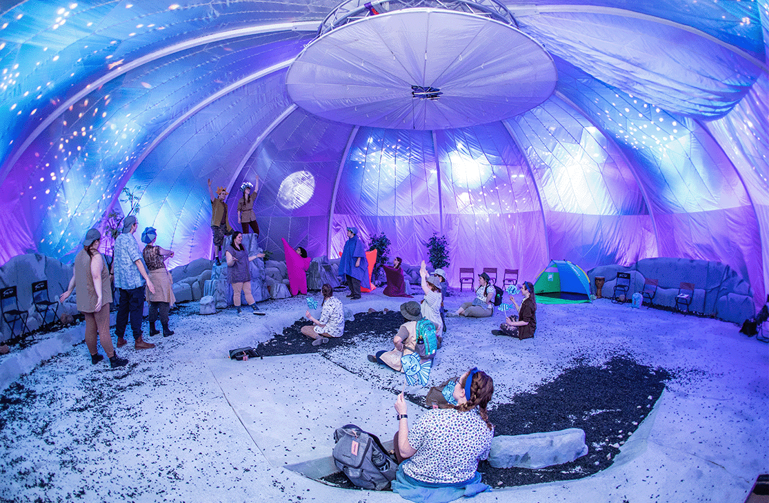 Students inside a dome tent.