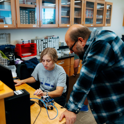 Student has a 1:1 conversation with professor on electrical engineering project.